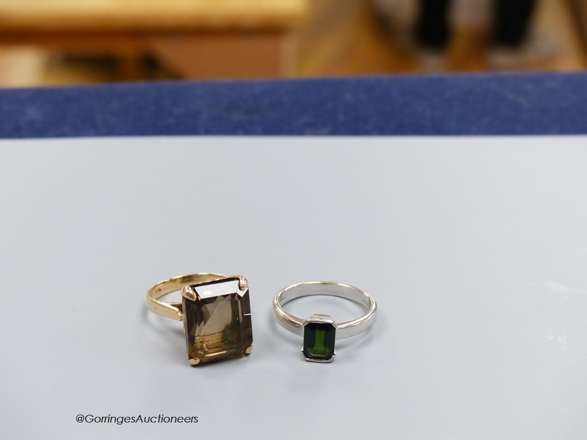 An 18ct white gold and tourmaline ring, size Q, gross 5g, and a 14k gold and smoky quartz ring, size M, gross 7g.